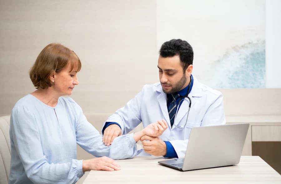 Doctor carefully examining female patient during health consultation in clinic office