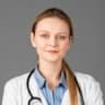 Confident female doctor in white coat with stethoscope offering expert medical care